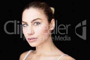 Portrait of beautiful woman posing against black background