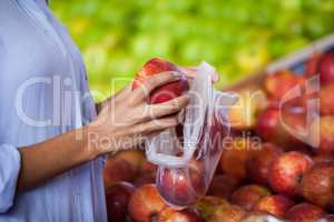 Woman buying an apple