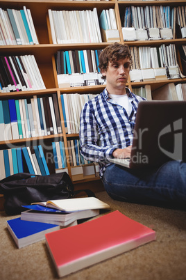 Student using laptop in library