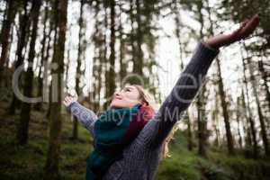 Beautiful woman standing with arms outstretched