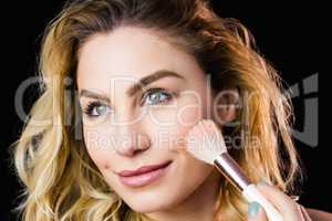 Beautiful woman posing with make-up brush