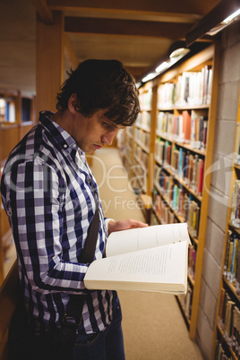 Student reading book in college library