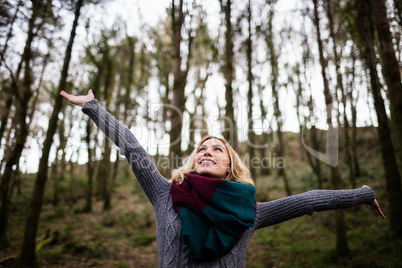 Beautiful woman standing with arms outstretched