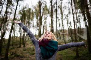 Beautiful woman standing with arms outstretched