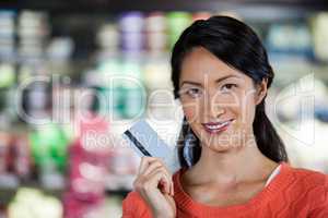 Portrait of woman holding credit card