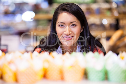 Portrait of woman looking at cupcakes