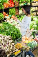 Woman buying carrot in organic section