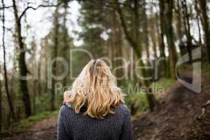 Woman standing in forest