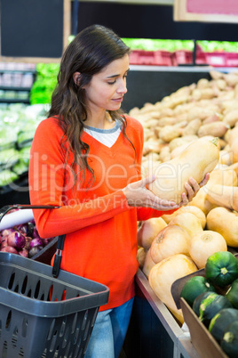 Woman holding vegetable in organic section