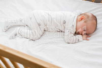 Baby boy sleeping on a cradle
