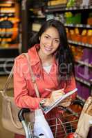 Woman writing in notepad