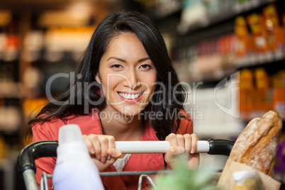 Happy woman with shopping cart