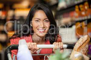 Happy woman with shopping cart