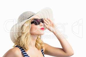 Beautiful woman posing with sunglasses against white background