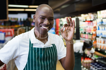 Smiling male staff standing in supermarket Smiling male staff standing in supermarket