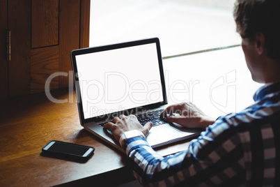 Student using laptop in college