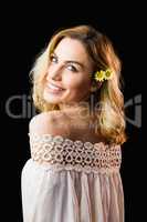 Portrait of beautiful smiling woman against black background