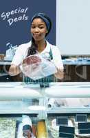 Portrait of female staff packing meat at counter