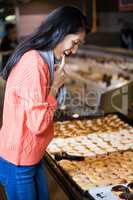 Excited woman selecting doughnuts