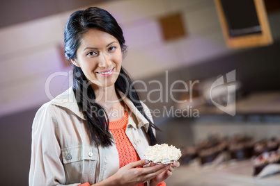 Portrait of woman holding sweet food