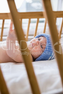 Baby lying on baby bed