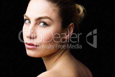 Portrait of beautiful woman posing against black background