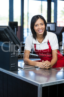 Female staff sitting at cash counter