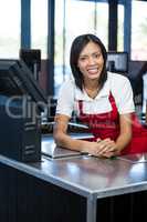 Female staff sitting at cash counter