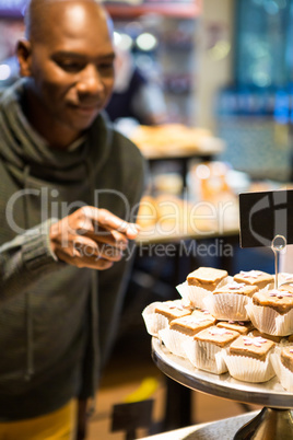 Smiling man purchasing sweet food