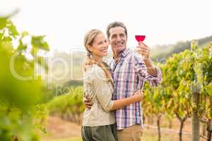 Happy couple looking at glass of wine