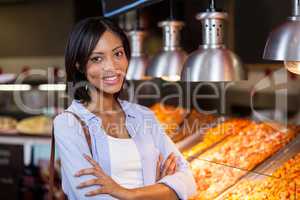 Happy woman standing at food counter