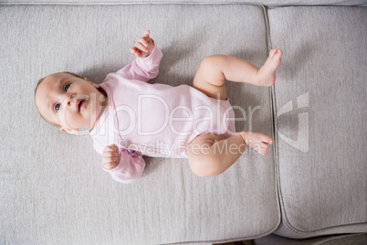 Baby lying on sofa in living room