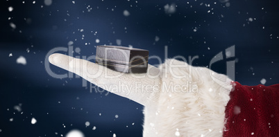 Composite image of santas hand shows a small box