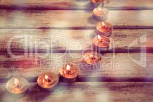 Candles burning on wooden plank