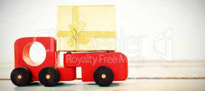 Toy tempo carrying christmas present against white background