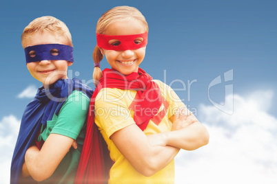 Composite image of happy brother and sister in cape and eye mask