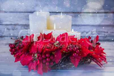 Candles decorated with flowers nest basket on wooden plank