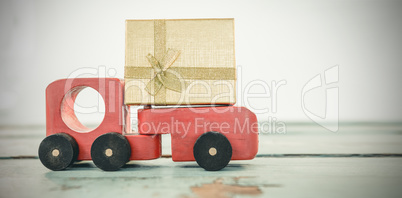 Toy tempo carrying christmas present against white background