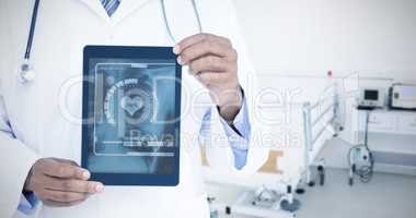 Composite image of a doctor showing digital tablet