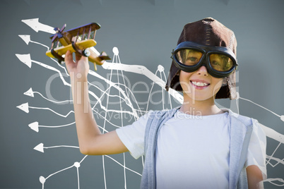 Composite image of portrait of boy wearing flying goggles with toy