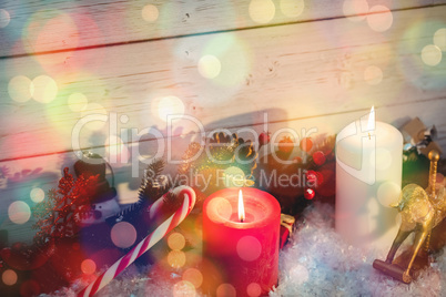 Illuminated candles with Christmas decorations