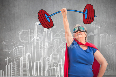 Composite image of senior woman disguise as superhero with hand raised
