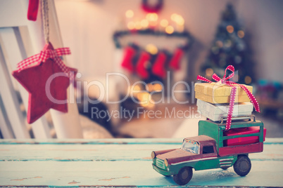 Composite image of car toy on wooden surface
