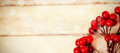 Fake red cherries on a plank