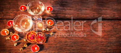 Wine glasses with christmas decorations on wooden table