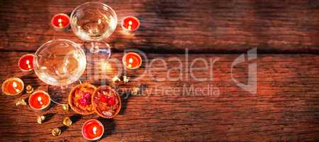 Wine glasses with christmas decorations on wooden table