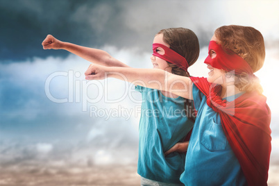 Composite image of sister and brother in red cape
