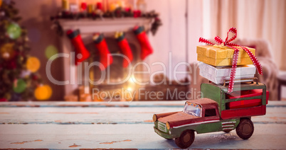Composite image of car toy on wooden surface