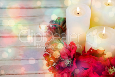 Candles decorated with flowers nest basket on wooden plank