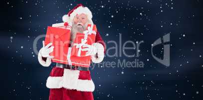 Composite image of santa carries a few presents